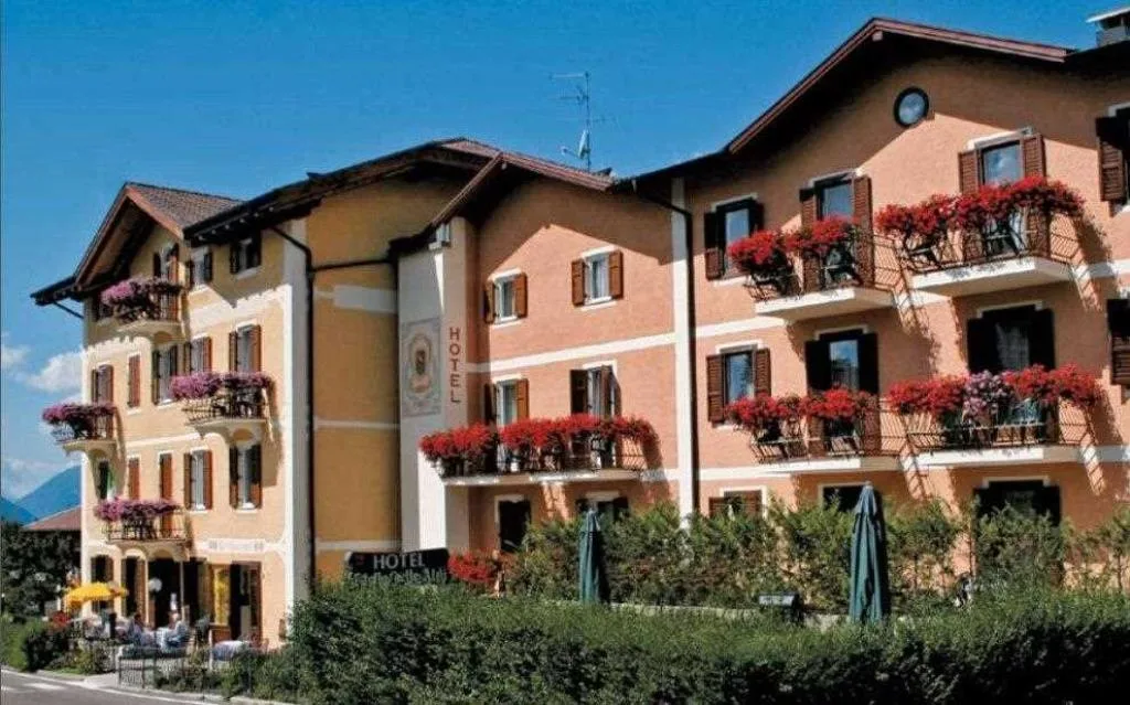 Esterno dell'hotel con balconi fioriti di gerani rossi in estate